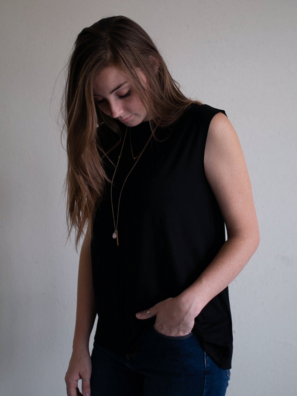 black sleeveless raw edge keyhole top