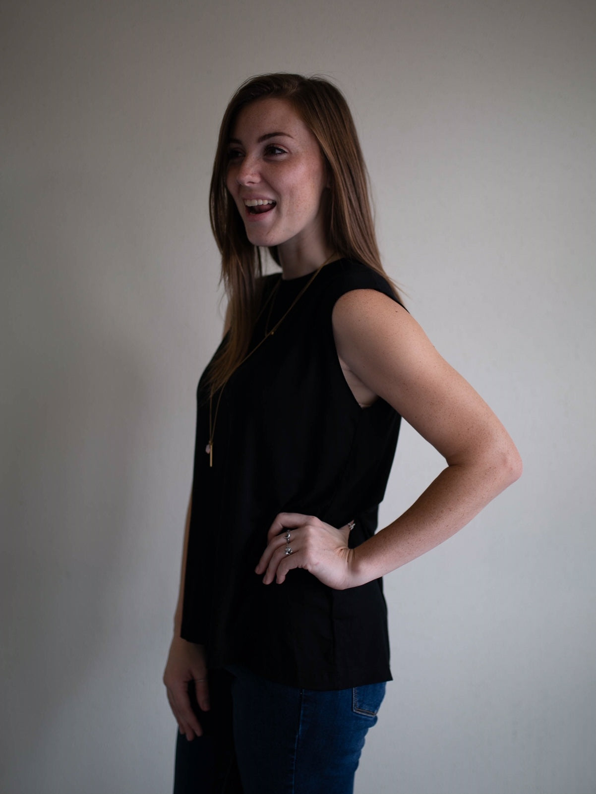 black sleeveless raw edge keyhole top