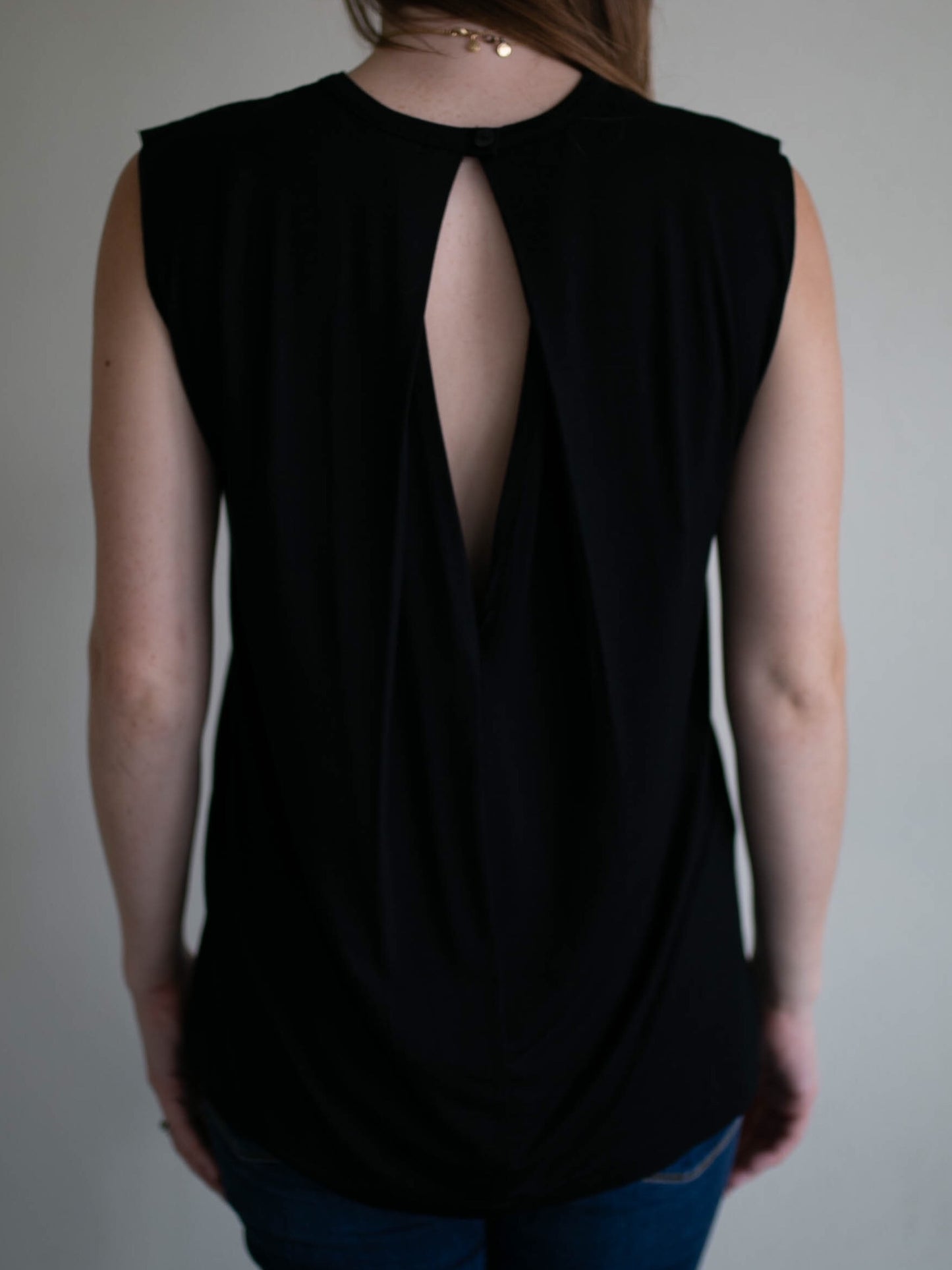 black sleeveless raw edge keyhole top