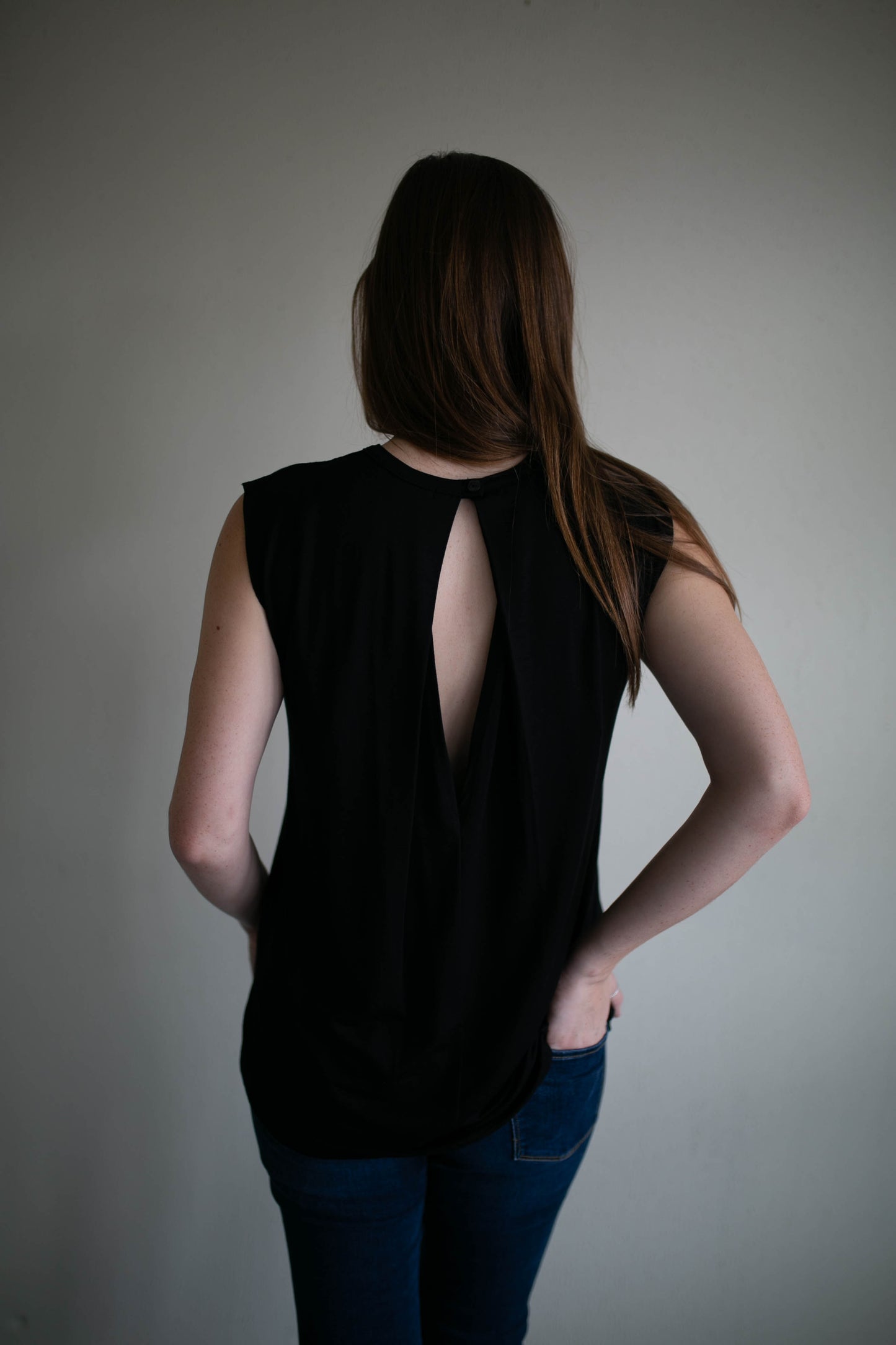 black sleeveless raw edge keyhole top